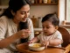 Indian mother feeding 10-month-old baby dal khichdi with ghee for healthy weight gain